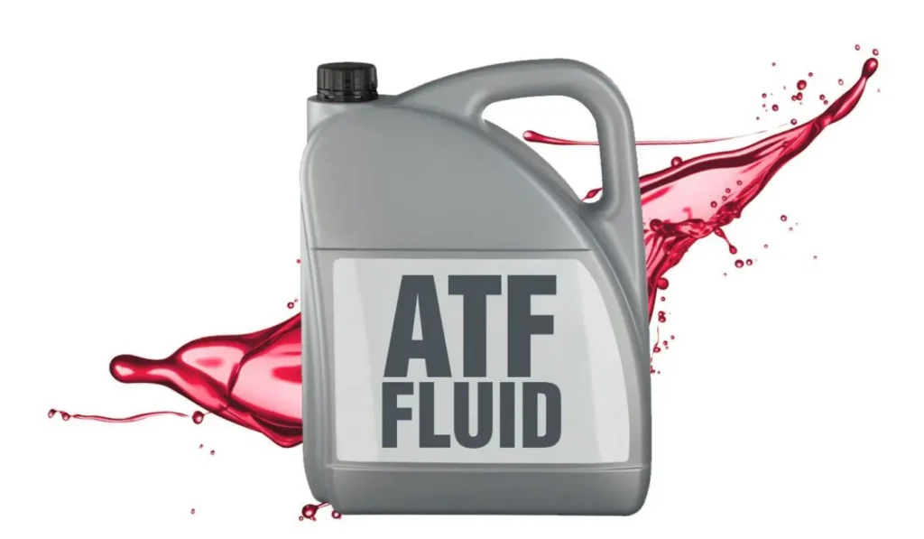 A gray plastic jug labeled "ATF FLUID" (Automatic Transmission Fluid) with a splash of reddish-pink fluid behind it.