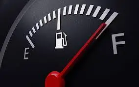 A close-up of a car's fuel gauge with the needle pointing towards "F" (Full), indicating good fuel economy.